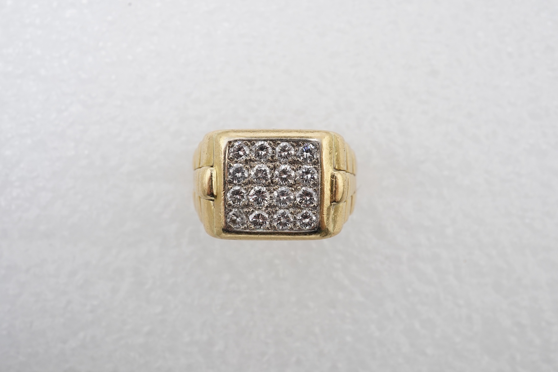 A gold and diamond signet ring